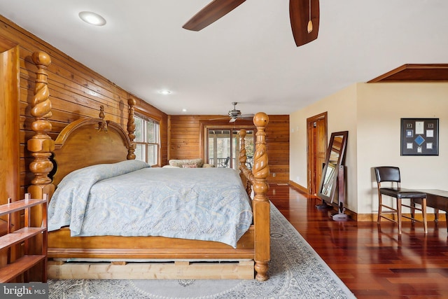 bedroom with wood walls, baseboards, wood finished floors, and recessed lighting