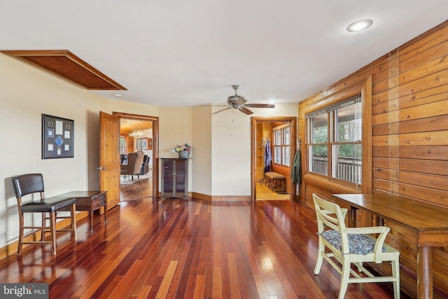 interior space featuring ceiling fan, wood-type flooring, and baseboards