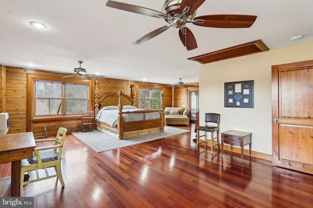 bedroom featuring baseboards, log walls, hardwood / wood-style floors, and recessed lighting