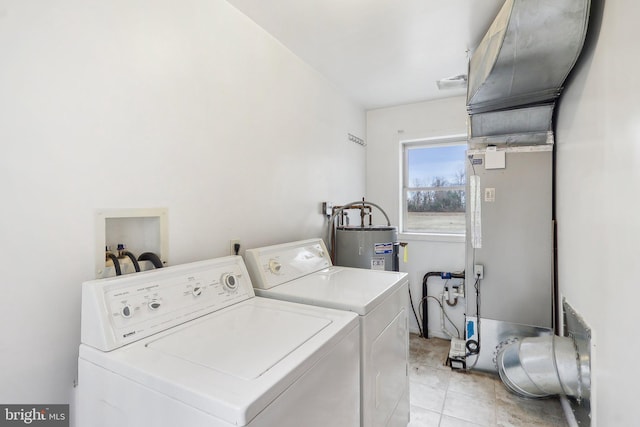 laundry area with washer and clothes dryer, light tile patterned floors, visible vents, water heater, and laundry area