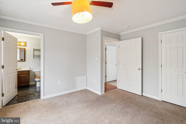 unfurnished bedroom featuring baseboards, carpet flooring, and crown molding