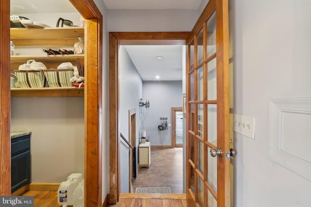 hall featuring baseboards and wood finished floors