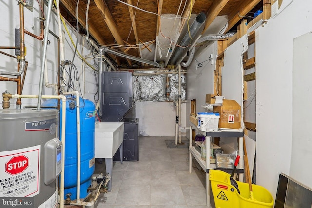 unfinished below grade area with a sink and electric water heater