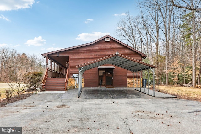 view of front of home featuring driveway and log veneer siding