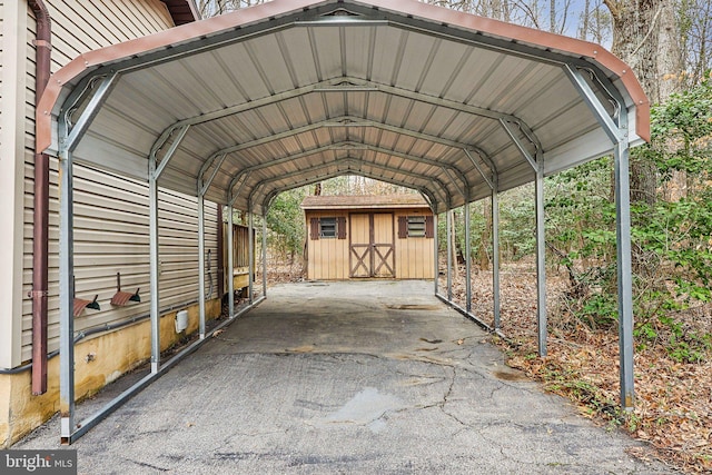 view of vehicle parking with a storage shed and a detached carport