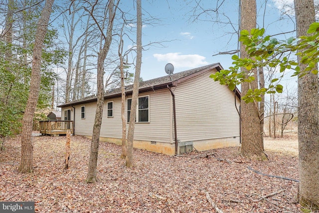 view of side of home featuring crawl space and a deck