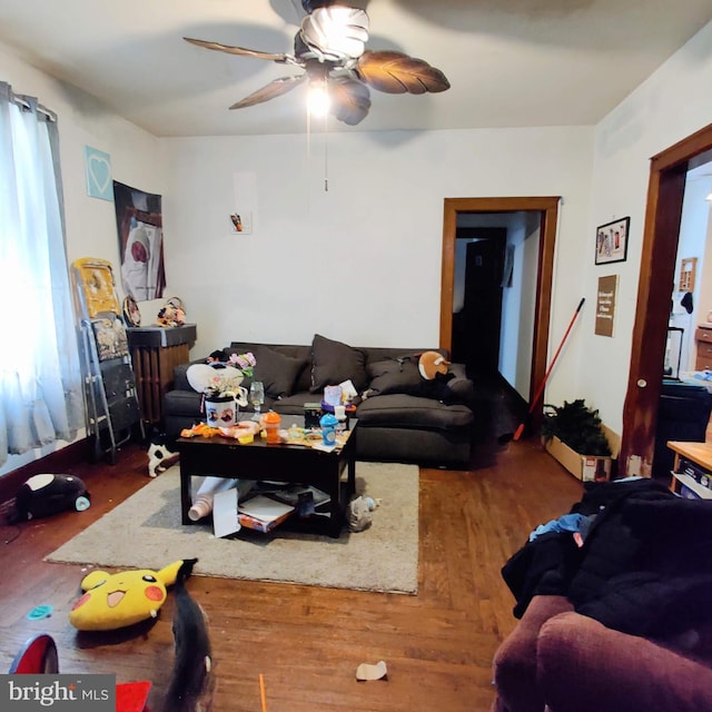 living area with ceiling fan and wood finished floors