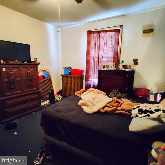 bedroom featuring a ceiling fan and radiator