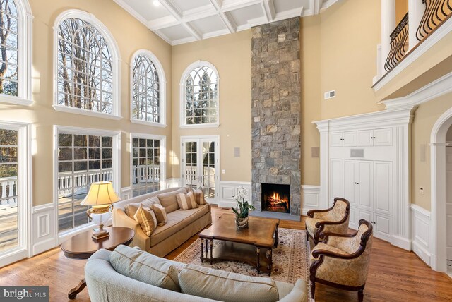 1221 Mottrom Dr, Mclean, VA 22101 - living room with a high ceiling, a fireplace, a wainscoted wall, visible vents, and wood finished floors