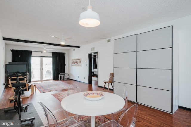 interior space featuring french doors, visible vents, a ceiling fan, a textured ceiling, and wood finished floors