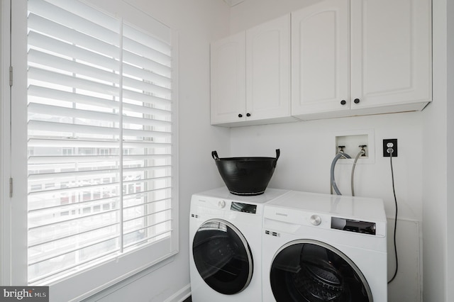 clothes washing area with cabinet space and washing machine and clothes dryer