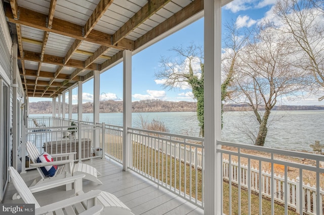 wooden deck featuring a water view