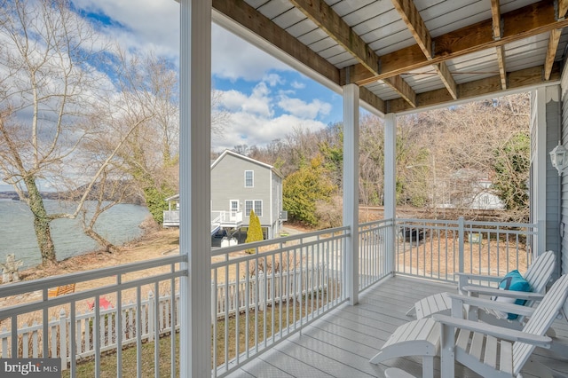 wooden deck featuring a water view