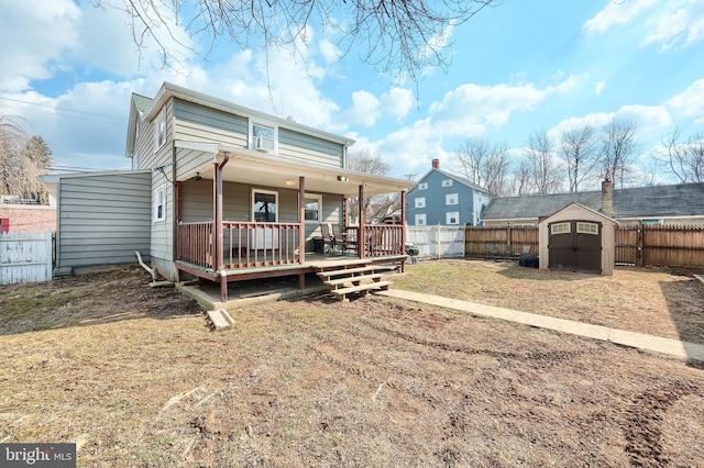 view of front facade featuring a storage shed, a deck, an outdoor structure, and a fenced backyard