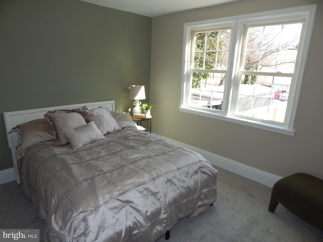 bedroom featuring carpet and baseboards