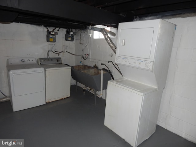 laundry area with stacked washer and dryer, washer and dryer, laundry area, and a sink