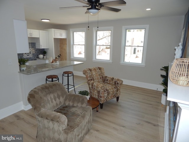 sitting room with baseboards, ceiling fan, recessed lighting, and light wood-style floors