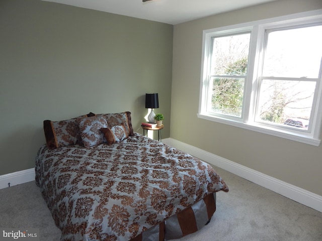 bedroom featuring carpet floors and baseboards