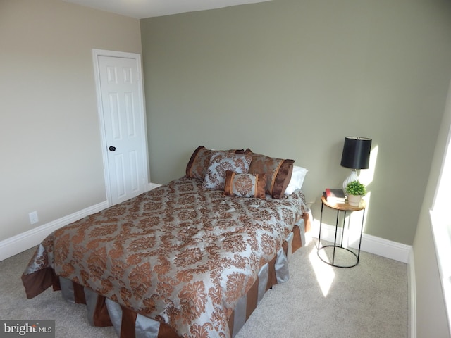 bedroom with carpet floors and baseboards