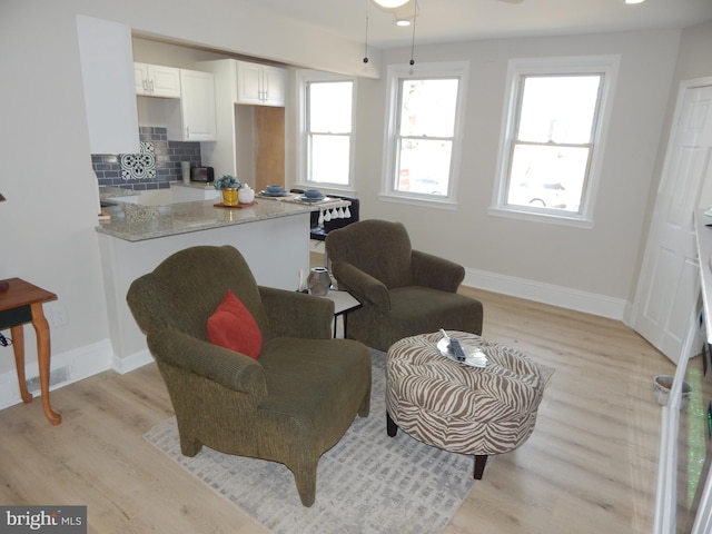 interior space with recessed lighting, plenty of natural light, light wood-style flooring, and baseboards