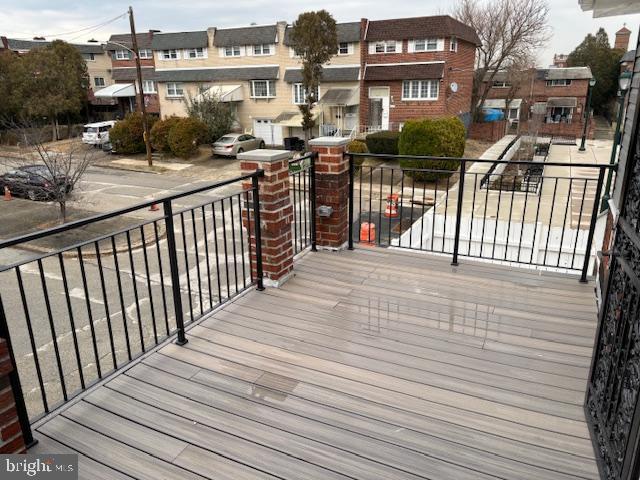 wooden terrace featuring a residential view