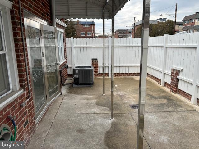 view of patio with a fenced backyard and central air condition unit