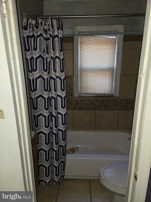 full bathroom featuring tile patterned flooring and toilet