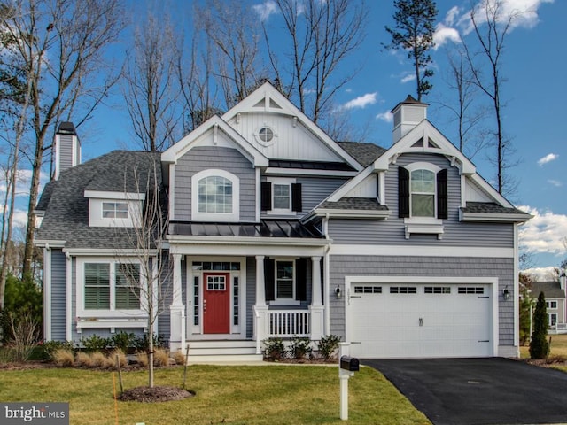 view of front of property with aphalt driveway, a standing seam roof, roof with shingles, and a chimney