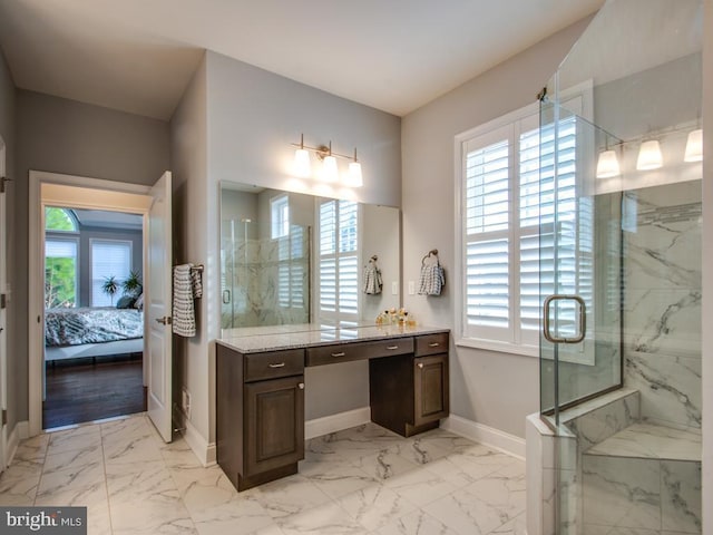 ensuite bathroom featuring marble finish floor, a marble finish shower, baseboards, and connected bathroom