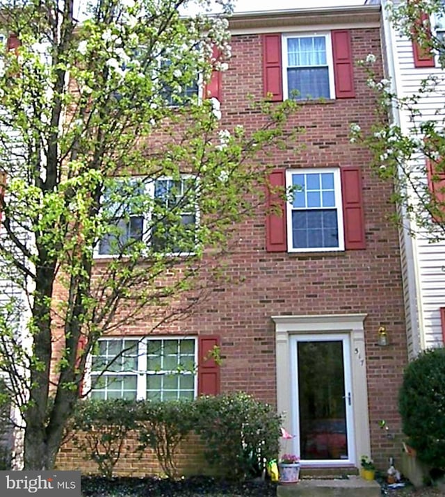 view of property with brick siding