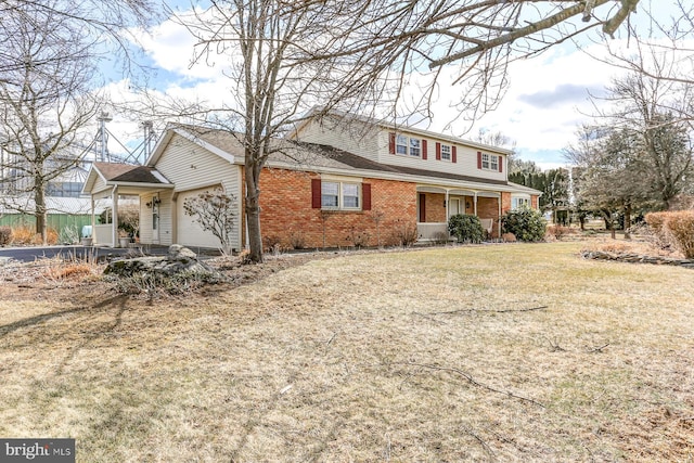 view of front of house with a garage, covered porch, a front yard, and brick siding