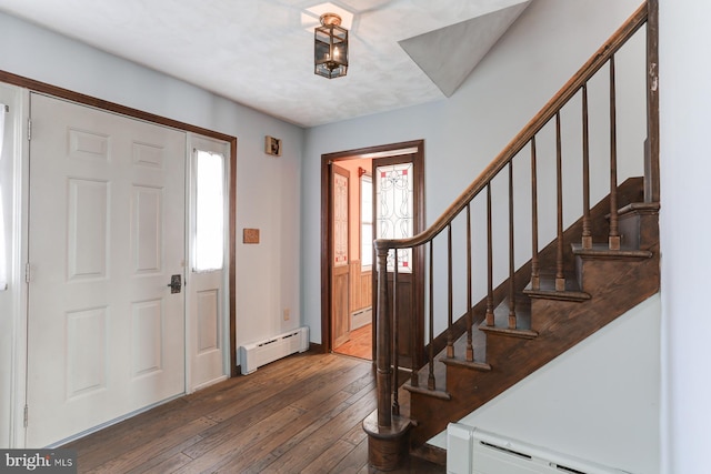 entrance foyer with stairs, dark wood-style flooring, and baseboard heating