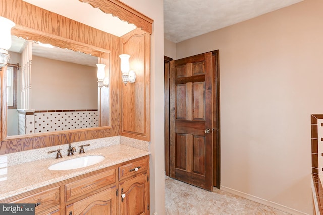 bathroom featuring baseboards and vanity