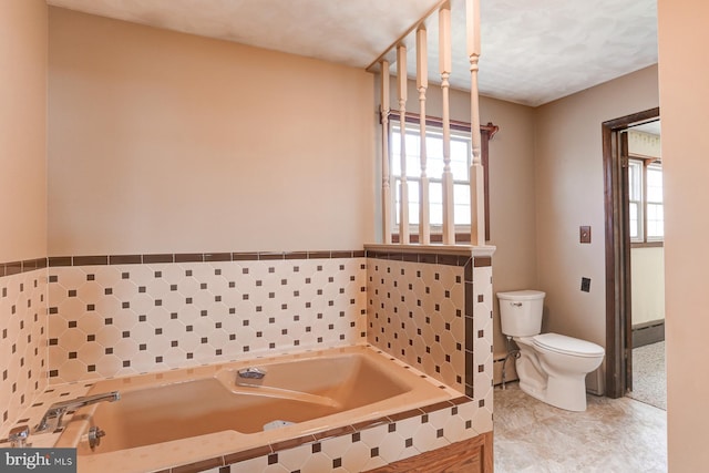 bathroom featuring a baseboard radiator, tile patterned flooring, a garden tub, and toilet