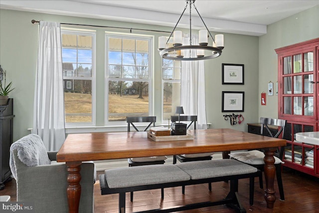 dining area featuring dark wood finished floors and a notable chandelier