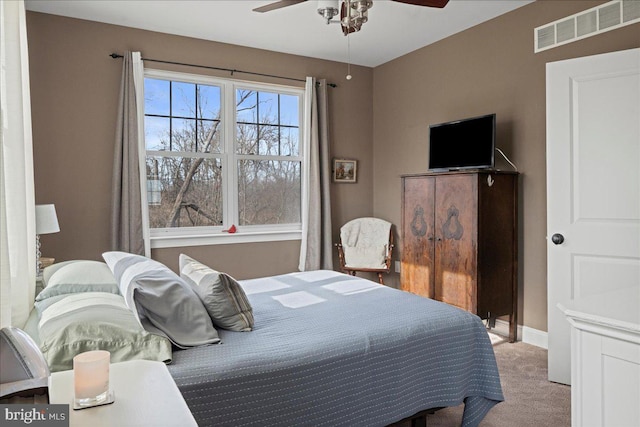 bedroom with ceiling fan, carpet, visible vents, and baseboards