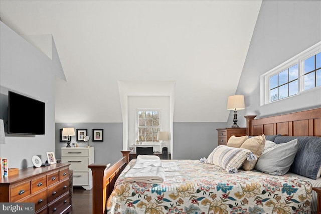 bedroom with dark wood-type flooring and vaulted ceiling