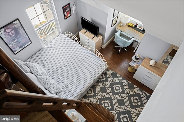 interior space with wood finished floors and baseboards