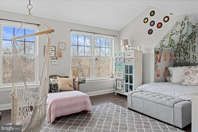 bedroom with lofted ceiling, baseboards, and wood finished floors