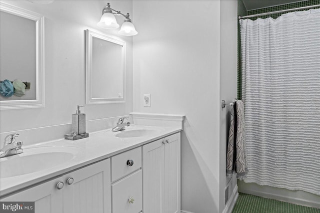 bathroom featuring double vanity, a sink, and a shower with curtain