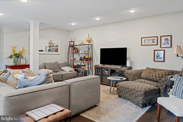 living room with ornate columns and recessed lighting