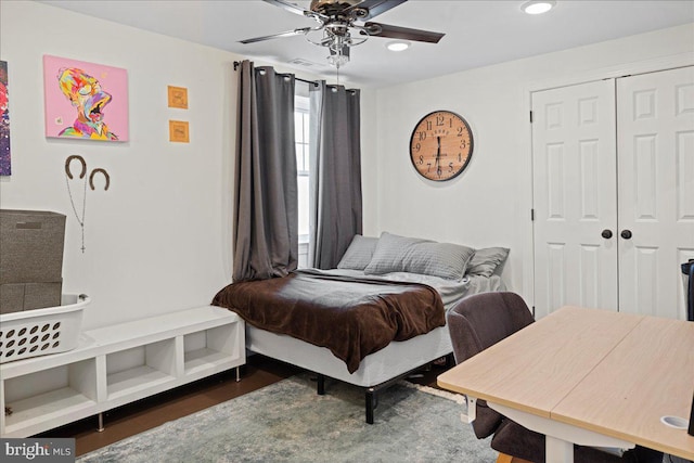 bedroom featuring a ceiling fan, a closet, and wood finished floors