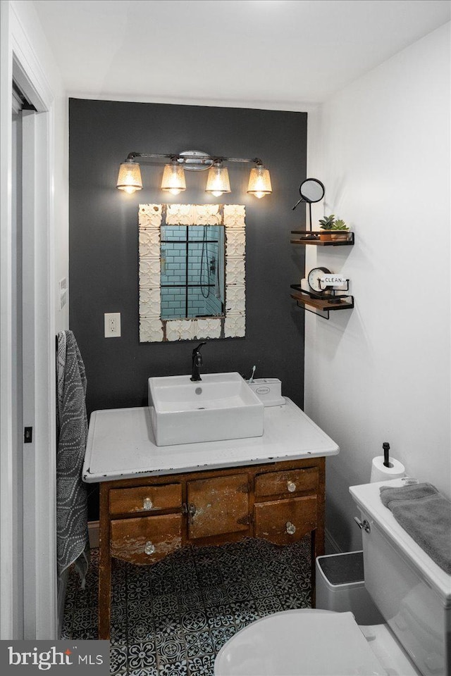 half bath featuring toilet and vanity