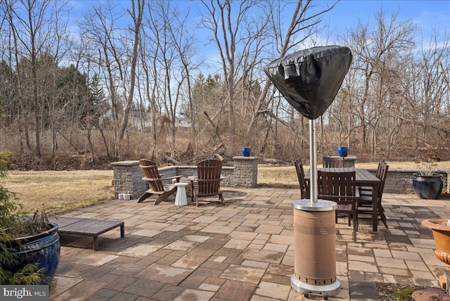 view of patio with a fire pit and outdoor dining area