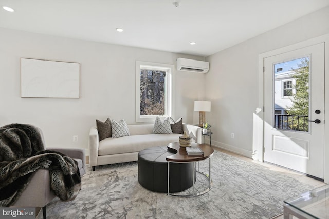 living area with recessed lighting, a wall mounted air conditioner, and baseboards