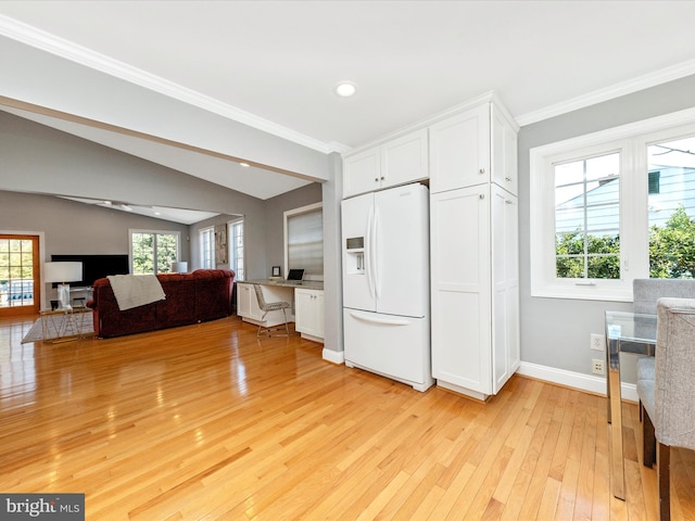 kitchen featuring lofted ceiling, a wealth of natural light, light wood-style flooring, white refrigerator with ice dispenser, and white cabinets