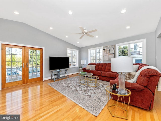 living room featuring recessed lighting, french doors, lofted ceiling, and light wood-style floors