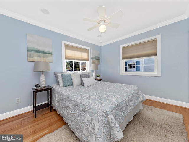 bedroom featuring baseboards, wood finished floors, a ceiling fan, and ornamental molding