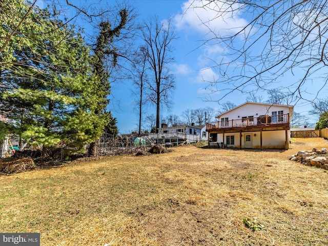 view of yard featuring a deck and fence