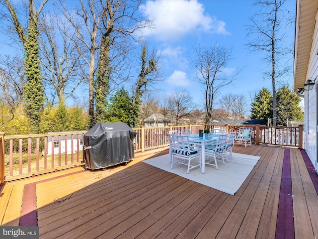 deck featuring grilling area and outdoor dining area